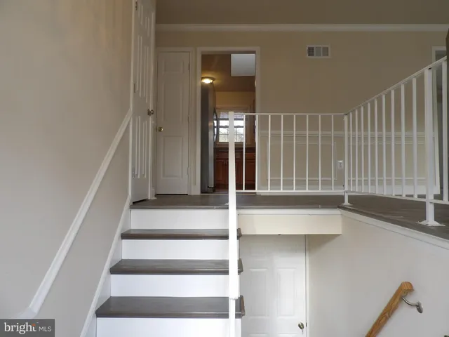 a view of staircase with white walls and windows