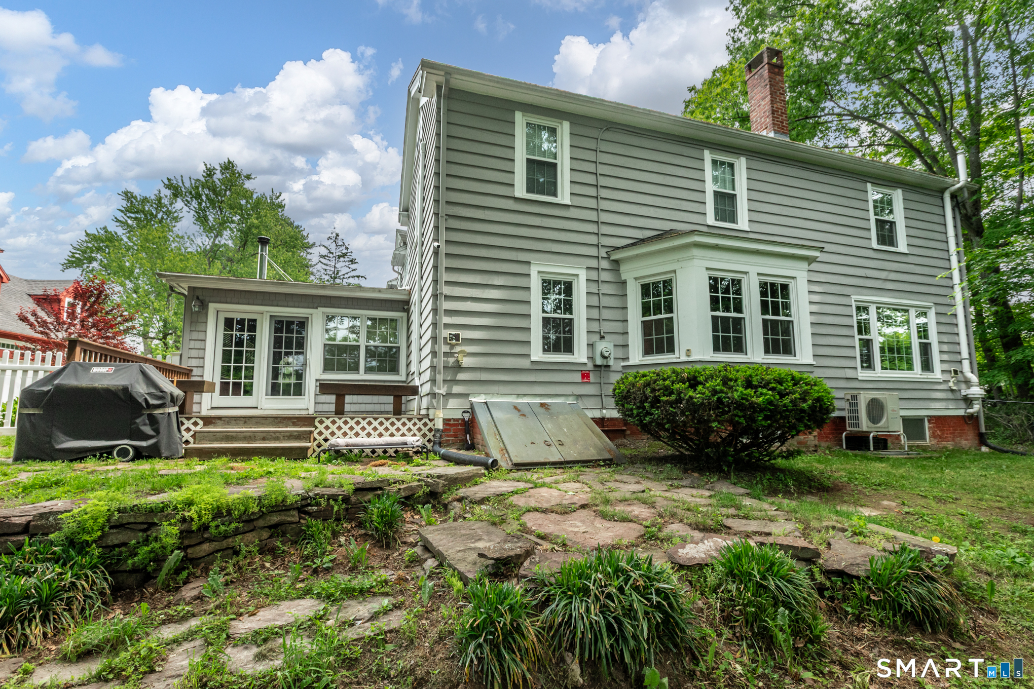 808 Branch Road Suffield, CT 06078 - Photo 28 of 40 a front view of a house with a yard and outdoor seating