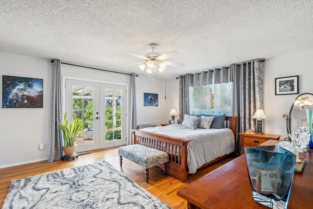 a bedroom with a bed and a chandelier