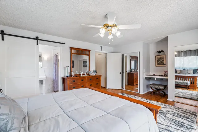 a bedroom with a large bed and a chandelier