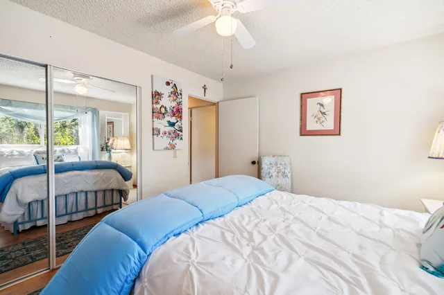 a bedroom with a large bed and a chandelier