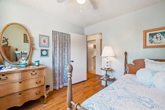 a bed room with a bed mirror and a mirror