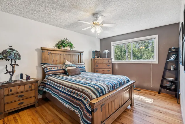 a bedroom with a bed and a chandelier