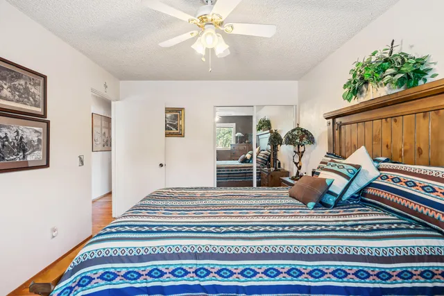 a bedroom with furniture and wooden floor