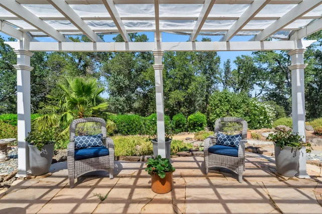 a view of a chairs and table in a patio