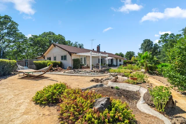 a view of a house with swimming pool and sitting area