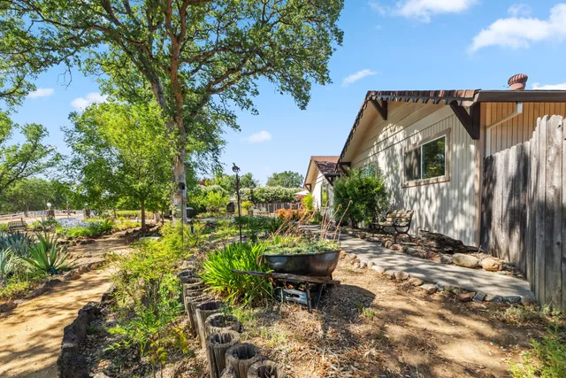 a backyard of a house with table and chairs