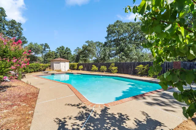a view of a swimming pool with a yard