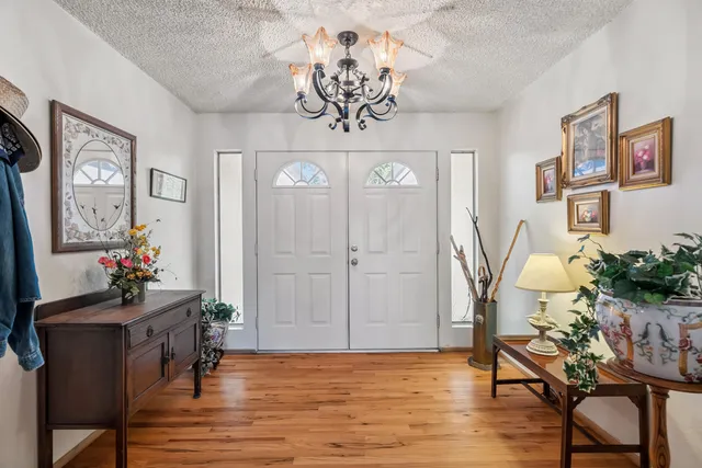 a view of a livingroom with furniture window and wooden floor
