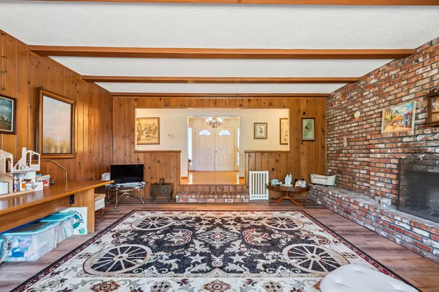 a living room with a couch and a potted plant