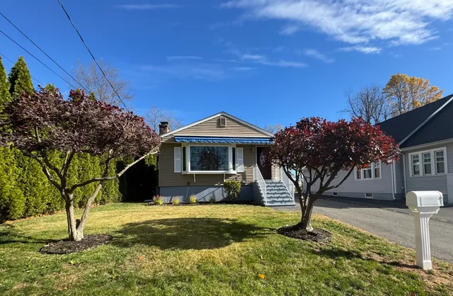 a front view of a house with a yard