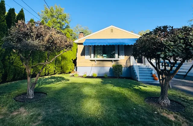 a front view of a house with garden