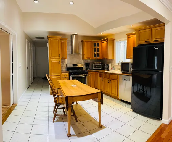 a kitchen with stainless steel appliances granite countertop a stove top oven and sink