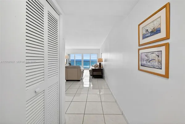 a view of a hallway to closet and a window