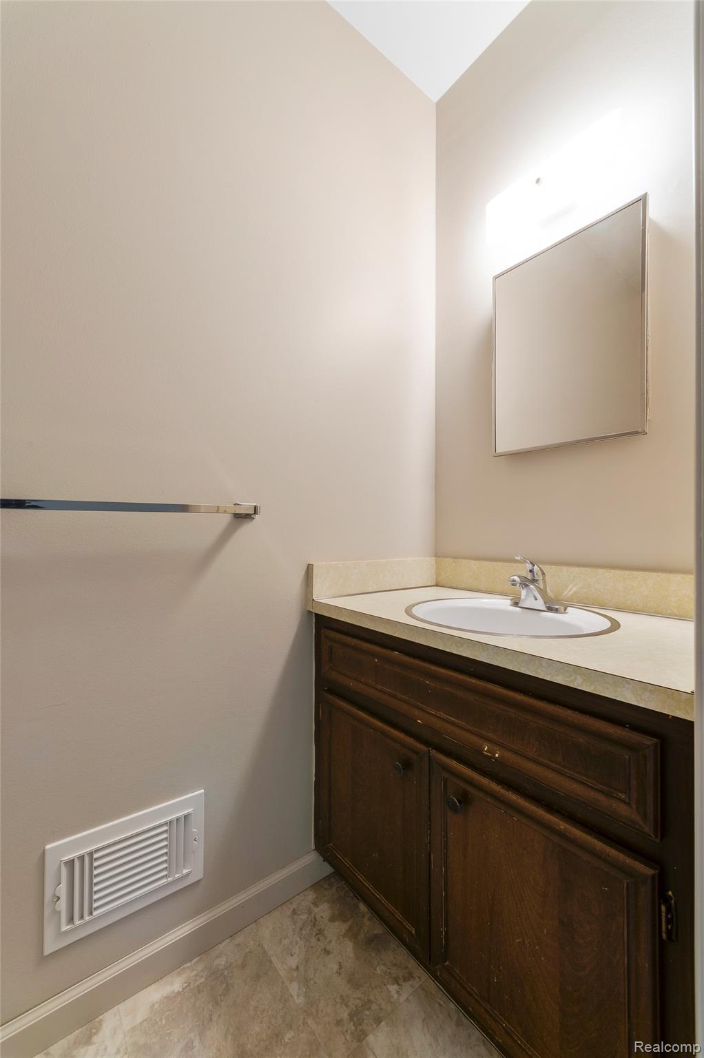 8887 Clark Road Clarkston, MI 48346 - Photo 17 of 40 Half bathroom with vanity and baseboards