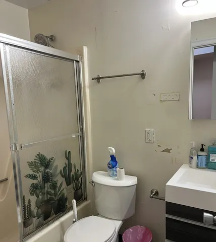 a bathroom with a toilet a sink and a shower
