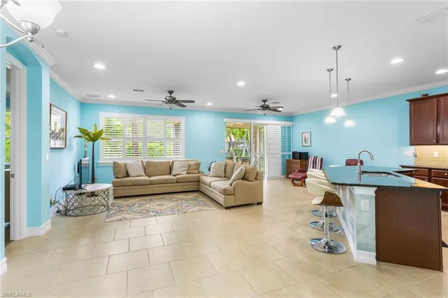 a kitchen with granite countertop a stove top oven cabinetry and stainless steel appliances