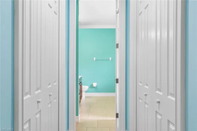 a room with furniture and a chandelier fan