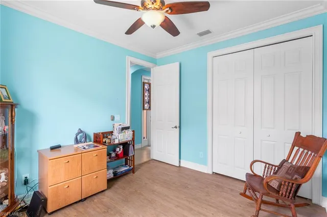 a bedroom with a bed cabinets and a book shelf