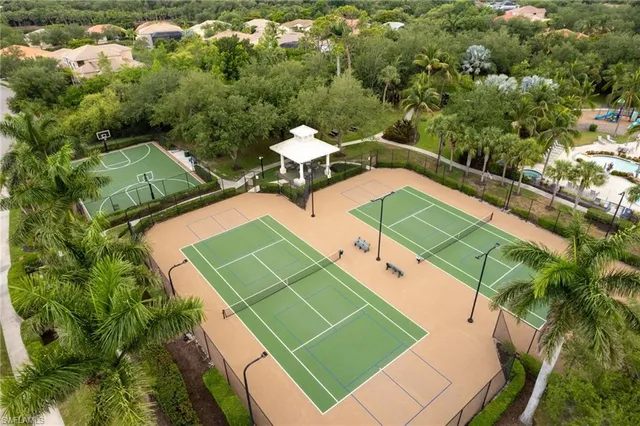 an aerial view of a tennis ground and a houses
