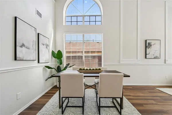 a view of a dining room with furniture and a window