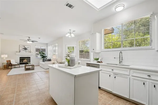 a kitchen with sink cabinets and living room