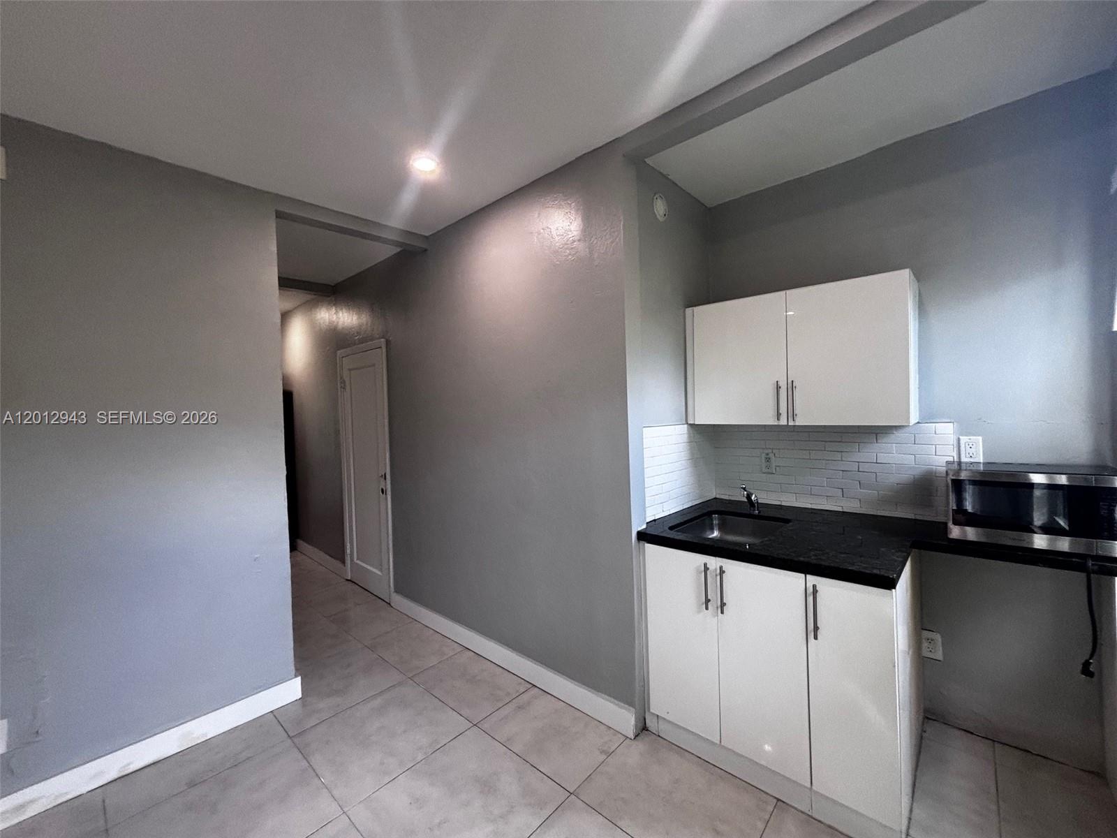 319 West 28th Street, Unit 15 Miami Beach, FL 33140 - Photo 3 of 6 a kitchen with a sink and cabinets