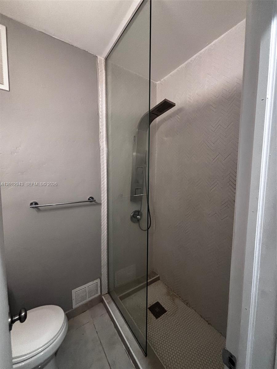 319 West 28th Street, Unit 15 Miami Beach, FL 33140 - Photo 5 of 6 a bathroom with a toilet and a shower