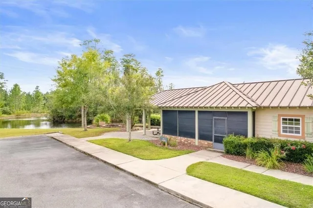 a view of a swimming pool with a yard and palm trees