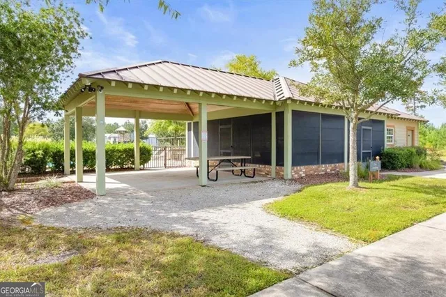 a view of a house with backyard porch and sitting area