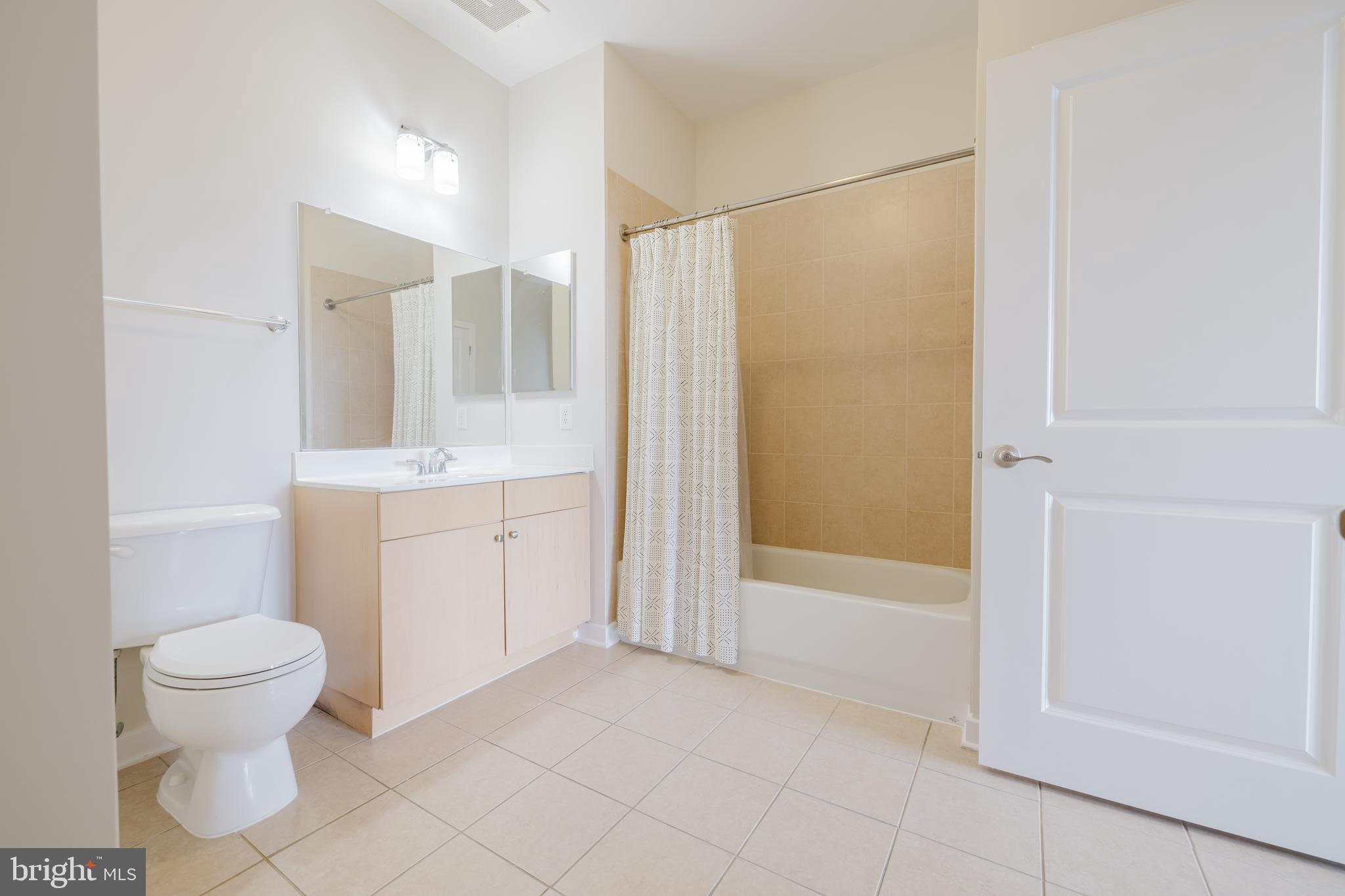 3201 St Paul Street, Unit 412 Baltimore, MD 21218 - Photo 15 of 23 a bathroom with a sink a toilet and shower