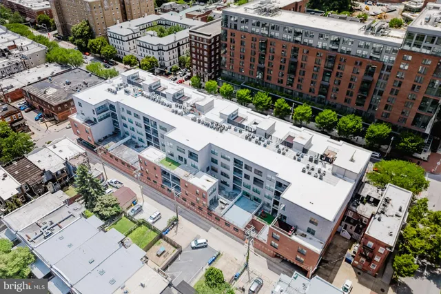 an aerial view of a house with garden space and street view