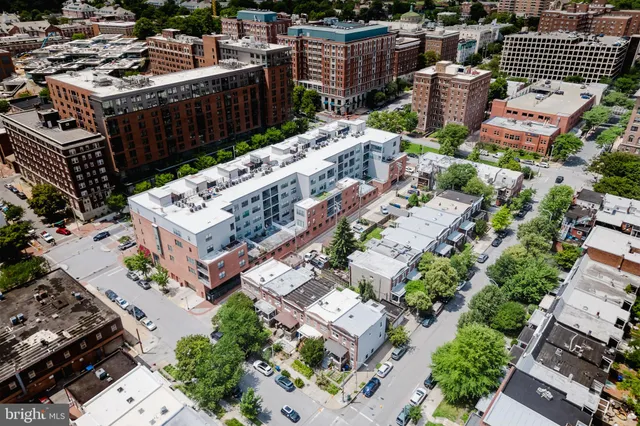 an aerial view of a house with roof deck and city view
