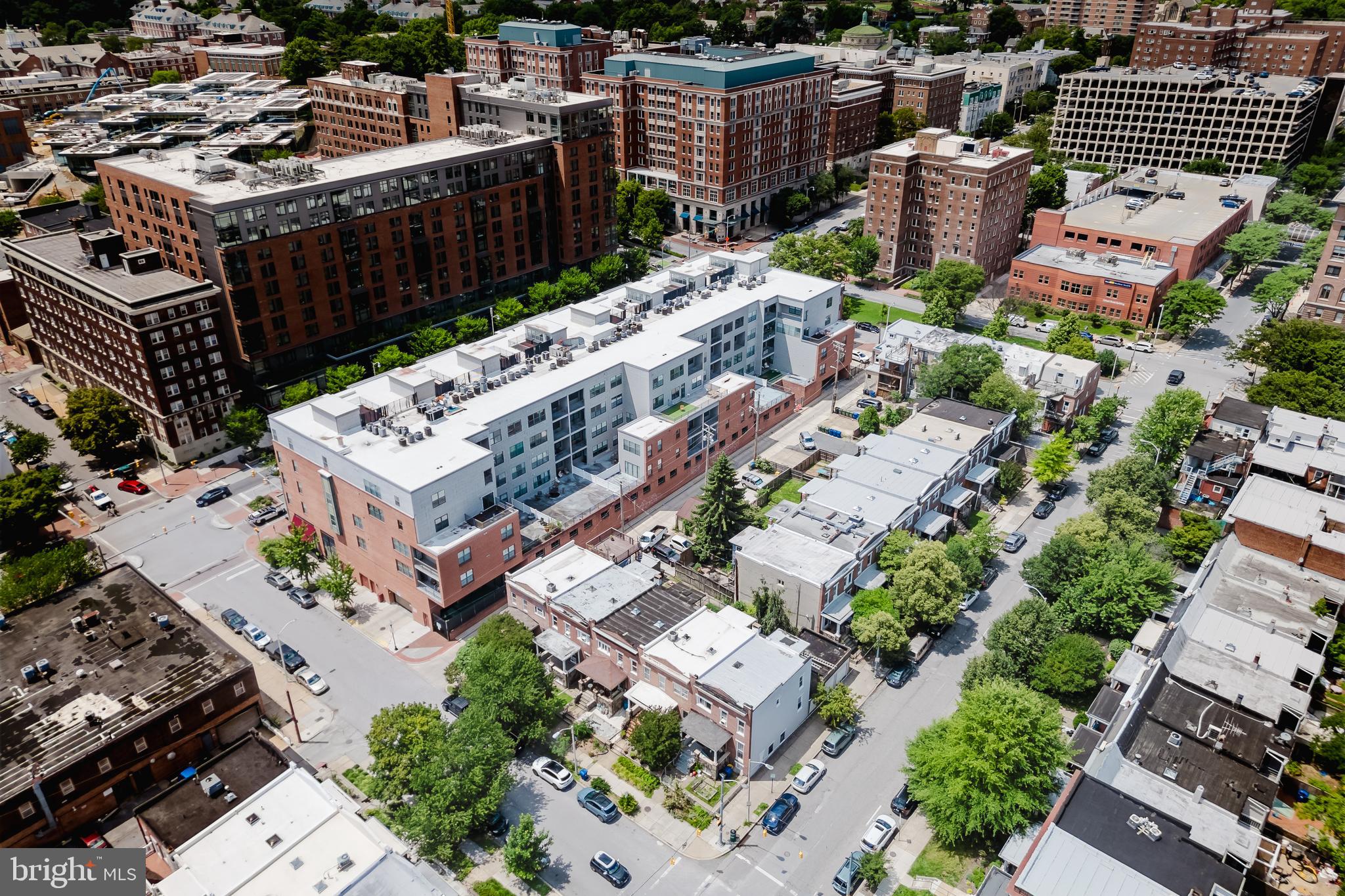 3201 St Paul Street, Unit 412 Baltimore, MD 21218 - Photo 18 of 23 an aerial view of a house with roof deck and city view