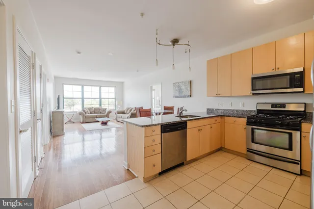 a kitchen with a stove a sink and a microwave
