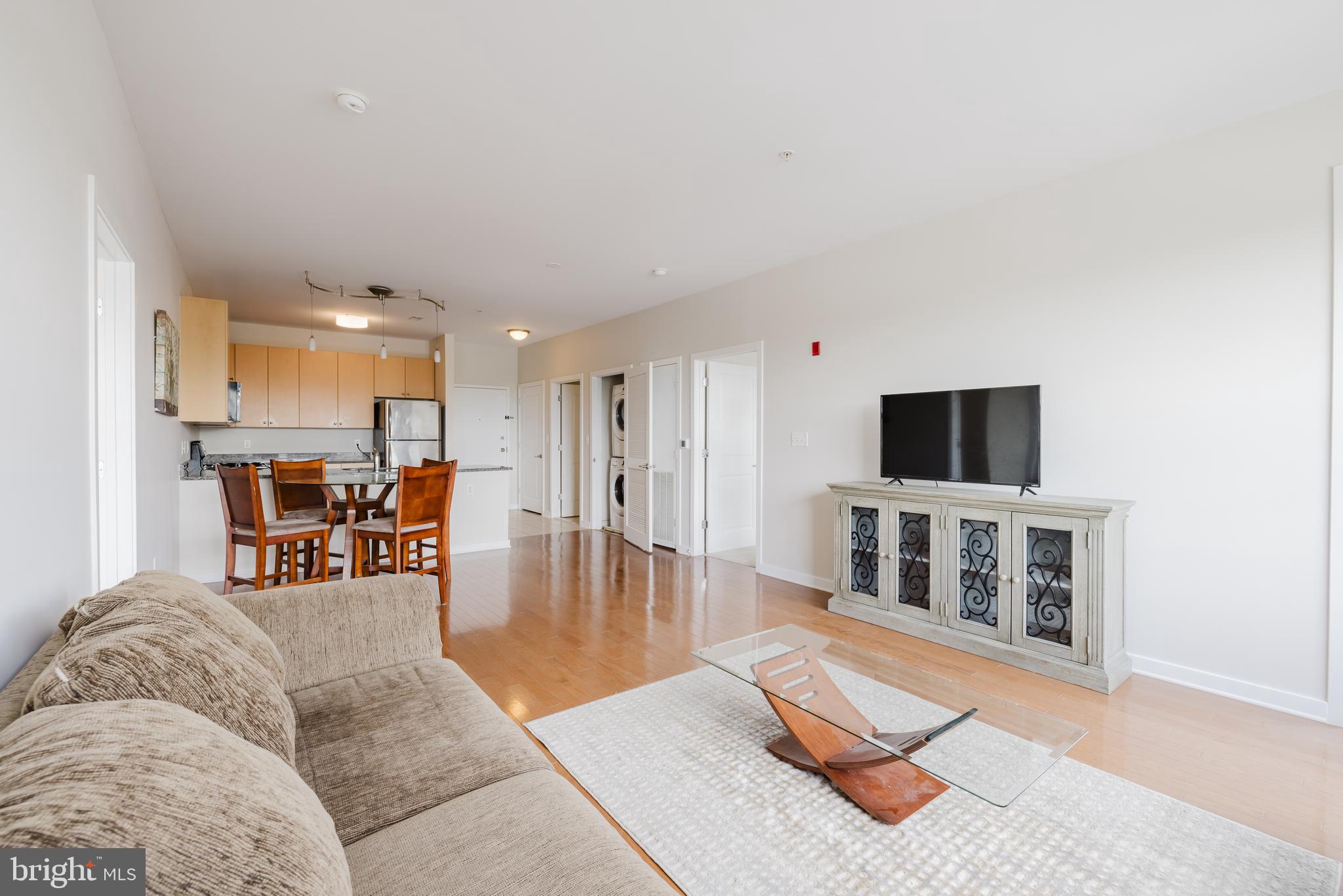 3201 St Paul Street, Unit 412 Baltimore, MD 21218 - Photo 3 of 23 a living room with furniture and a flat screen tv