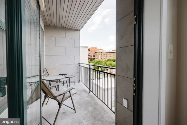 a view of a balcony with furniture