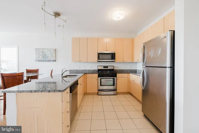 a kitchen with a refrigerator sink and microwave