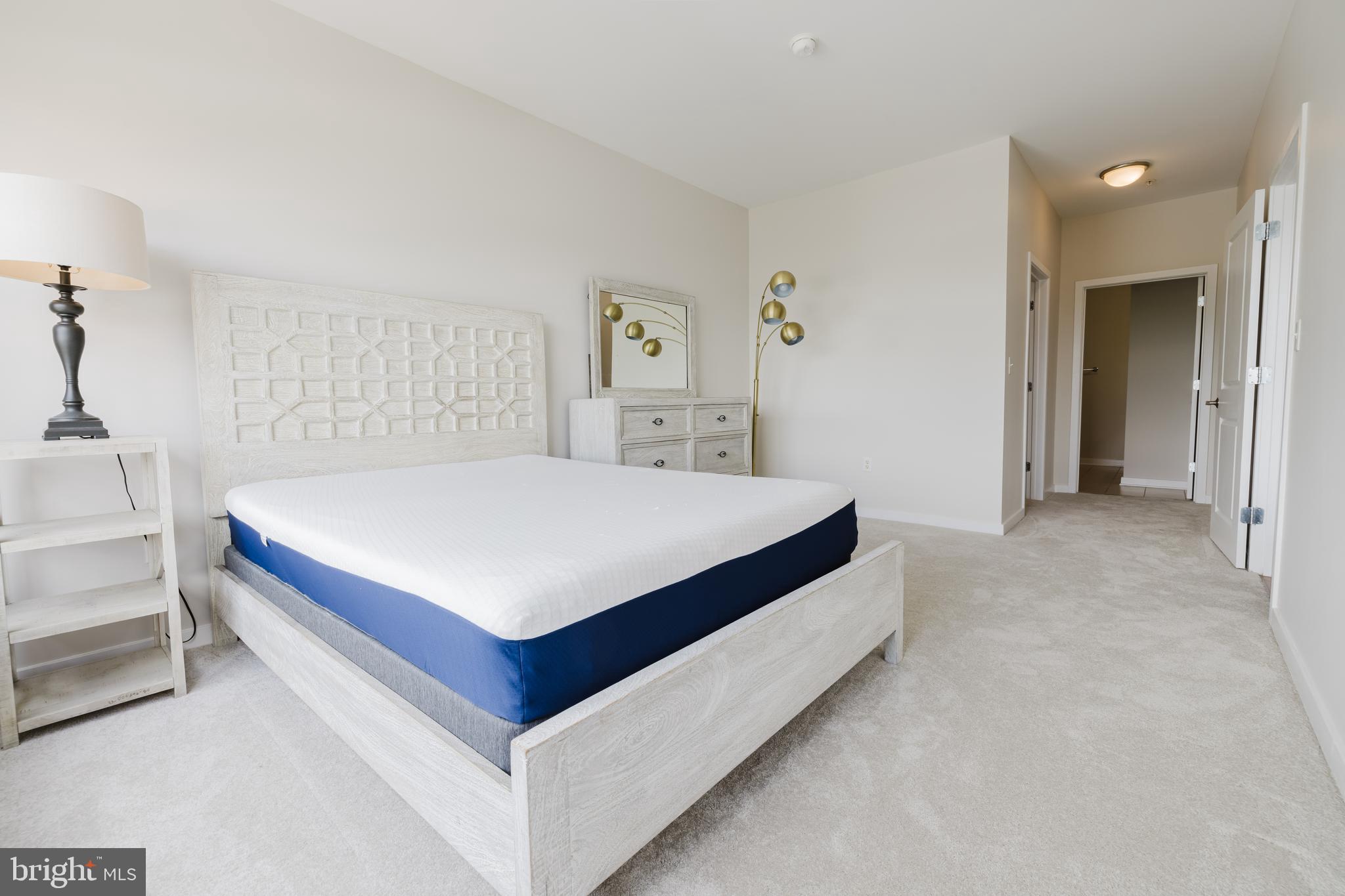 3201 St Paul Street, Unit 412 Baltimore, MD 21218 - Photo 9 of 23 a bedroom with a bed and a table