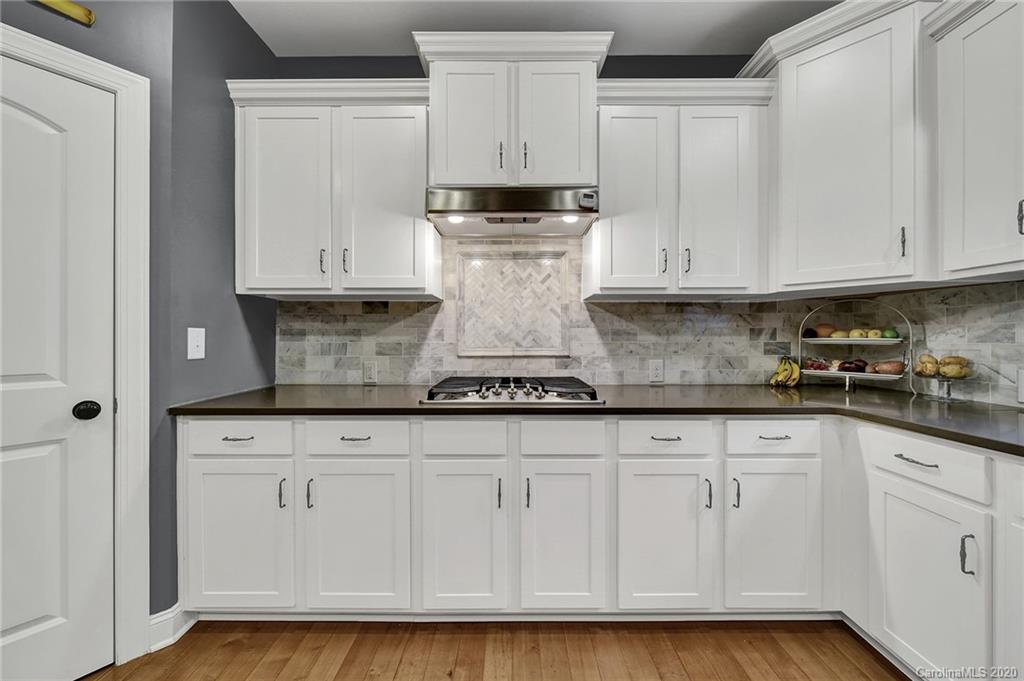 309 Calming Way Tega Cay, SC 29708 - Photo 15 of 41 a kitchen with stainless steel appliances granite countertop a stove a sink and white cabinets