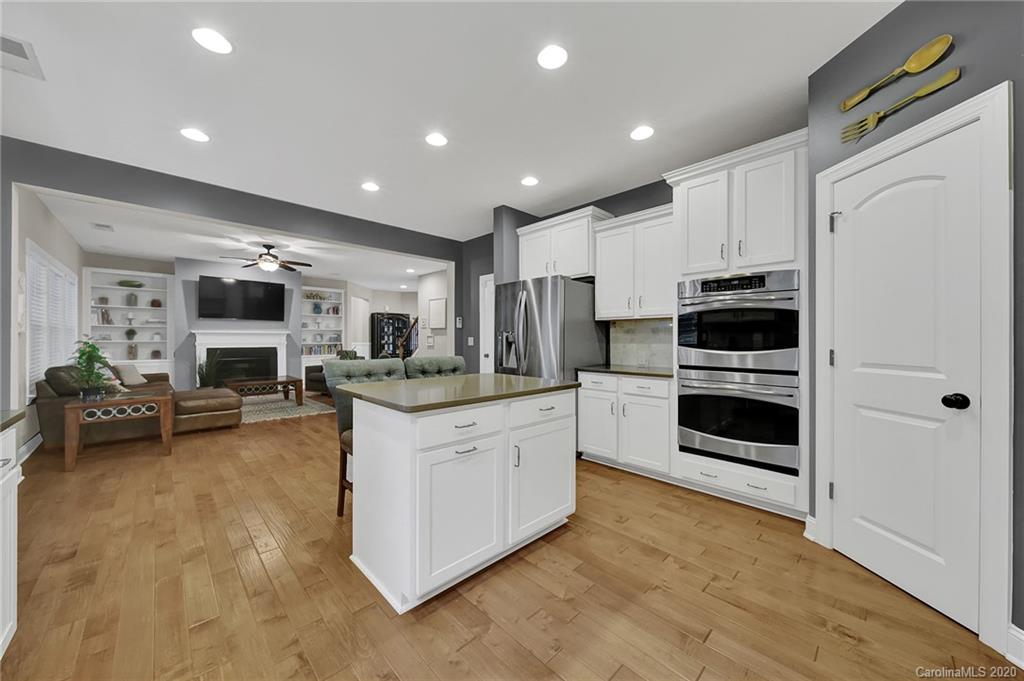 309 Calming Way Tega Cay, SC 29708 - Photo 16 of 41 a kitchen with stainless steel appliances kitchen island granite countertop a stove and a refrigerator
