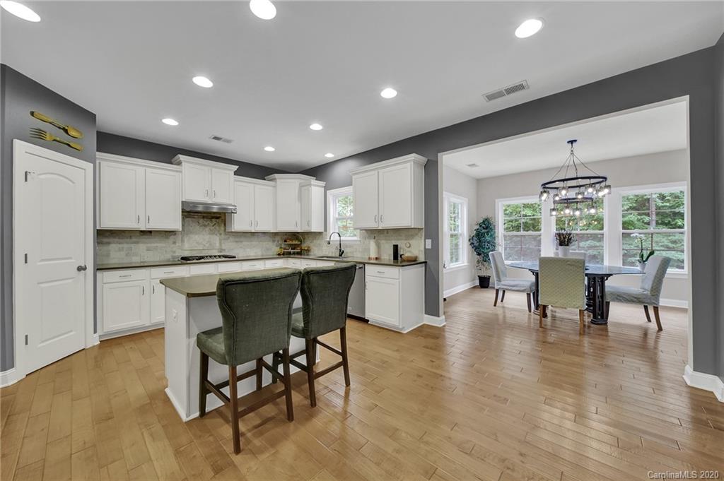 309 Calming Way Tega Cay, SC 29708 - Photo 17 of 41 a kitchen with a dining table chairs and view living room