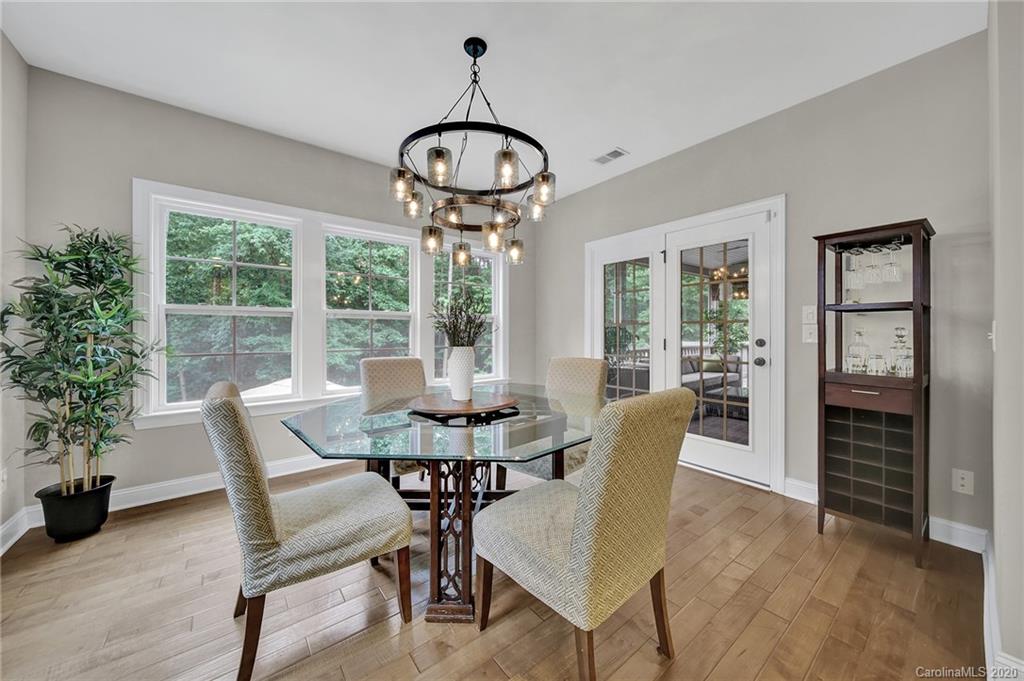 309 Calming Way Tega Cay, SC 29708 - Photo 19 of 41 a view of a dining room with furniture wooden floor and chandelier