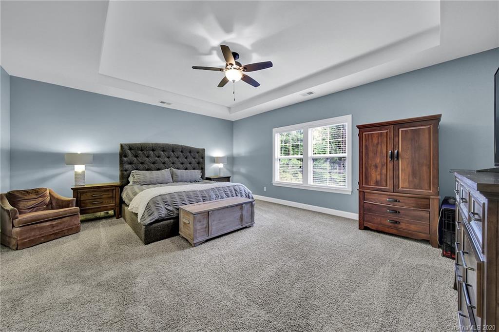 309 Calming Way Tega Cay, SC 29708 - Photo 20 of 41 a bedroom with a bed a dresser and a window