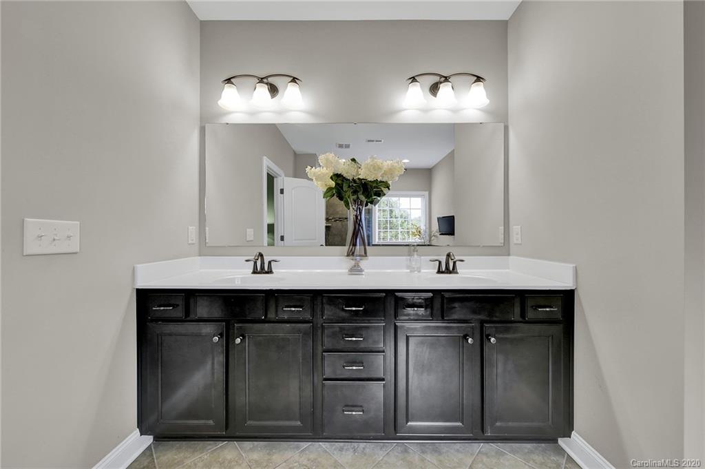 309 Calming Way Tega Cay, SC 29708 - Photo 23 of 41 a bathroom with a sink and a mirror