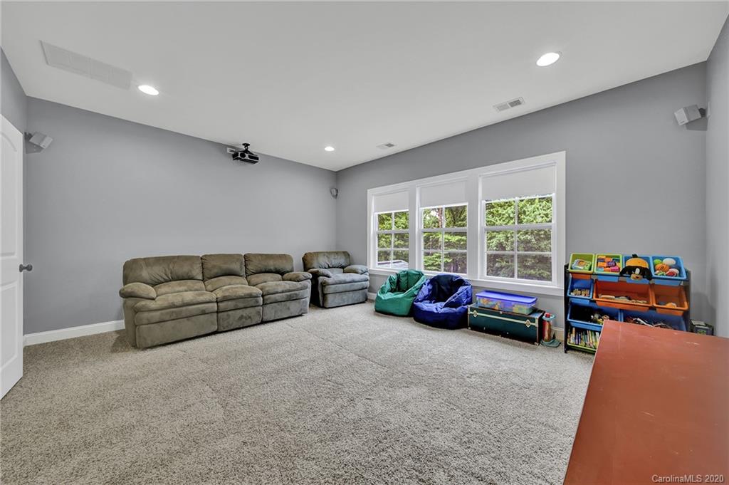 309 Calming Way Tega Cay, SC 29708 - Photo 25 of 41 a living room with furniture and a floor to ceiling window