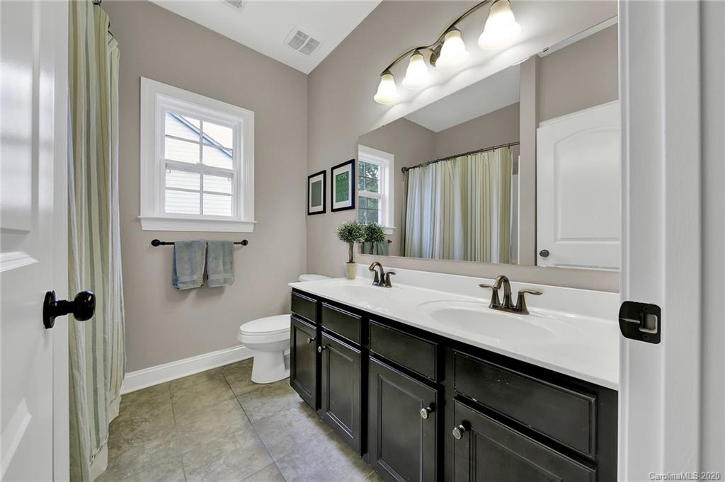 309 Calming Way Tega Cay, SC 29708 - Photo 26 of 41 a bathroom with a double vanity sink toilet and mirror