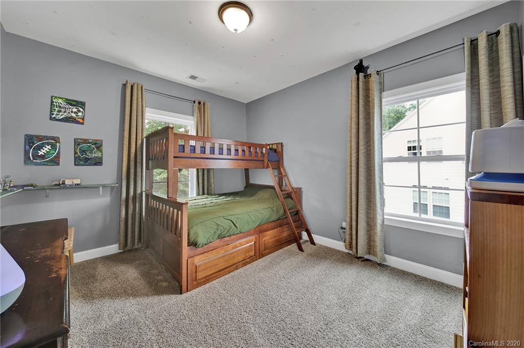 309 Calming Way Tega Cay, SC 29708 - Photo 27 of 41 a bedroom with a bed and a window