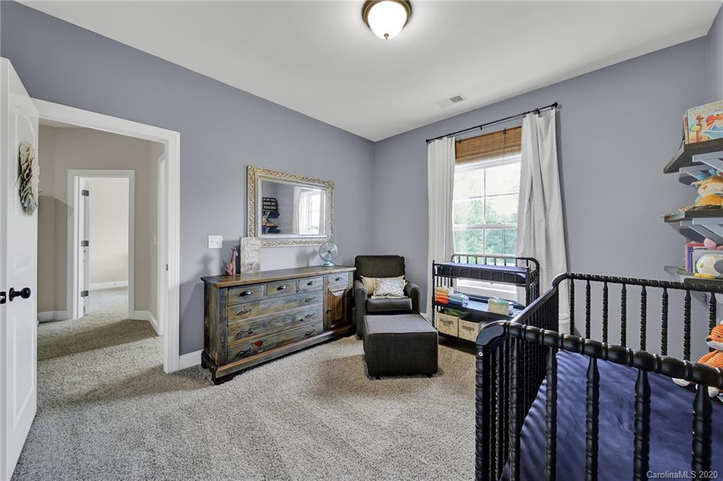 309 Calming Way Tega Cay, SC 29708 - Photo 28 of 41 a bedroom with furniture and a window