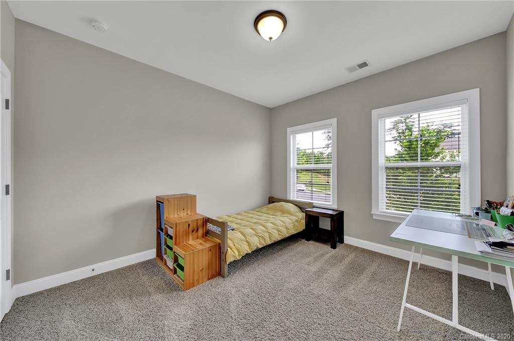 309 Calming Way Tega Cay, SC 29708 - Photo 29 of 41 a bed room with a bed and a chair